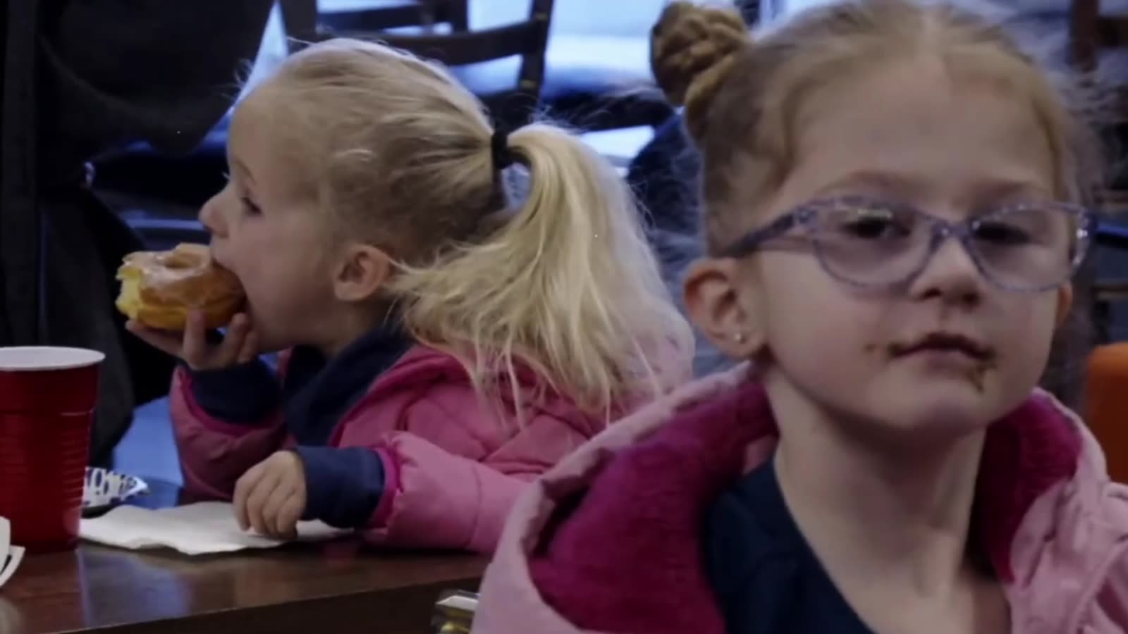 A smiling girl with a pink bow at Venture Kids